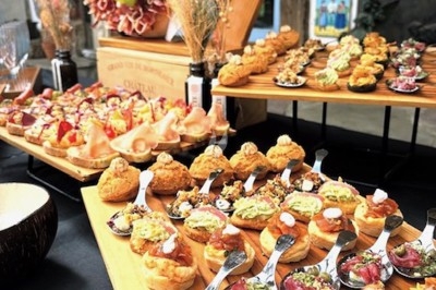 Gâteau à plusieurs étages décoré de fraises, myrtilles et roses rouges, avec des pailles en décoration.