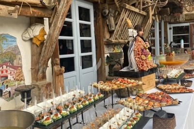 Gâteau à plusieurs étages décoré de fraises, myrtilles et roses rouges, avec des pailles en décoration.
