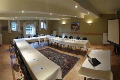 Vue d'un marché couvert avec des stands de produits locaux, des visiteurs et une architecture en pierre et bois.