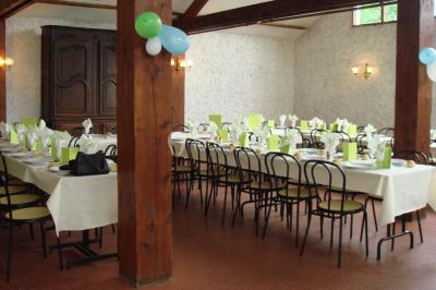 Cuisine simple avec évier en inox, étagères mobiles, cuisinière blanche et sol en carrelage rouge.