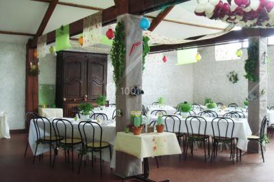 Cuisine simple avec évier en inox, étagères mobiles, cuisinière blanche et sol en carrelage rouge.