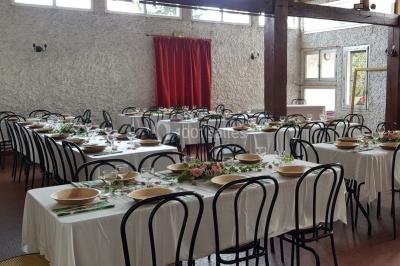 Cuisine simple avec évier en inox, étagères mobiles, cuisinière blanche et sol en carrelage rouge.