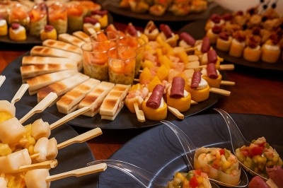 Assiette gastronomique avec tranches de poisson, agrumes, radis, croustillant décoratif et points de sauce balsamique.