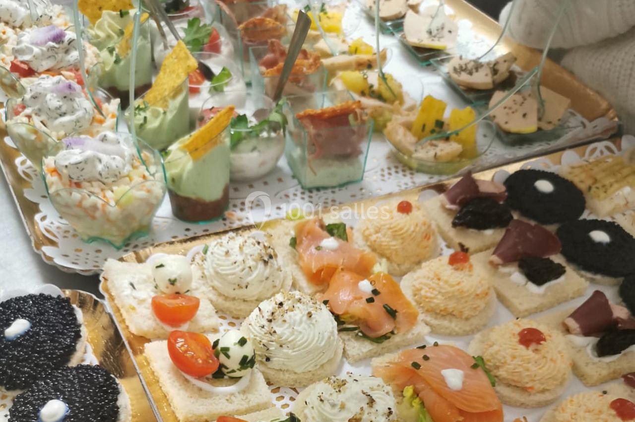 Plateau de bouchées apéritives variées avec saumon, caviar, verrines et autres garnitures colorées.