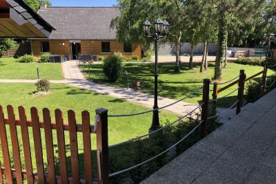 Chambre lumineuse avec lit double, bureau, télévision murale, fauteuil et fenêtre donnant sur l'extérieur.