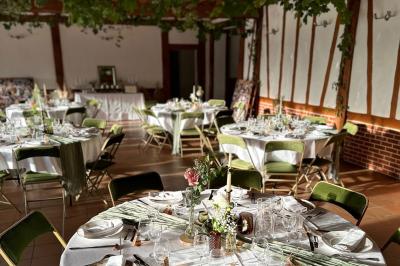 Chambre lumineuse avec lit double, bureau, télévision murale, fauteuil et fenêtre donnant sur l'extérieur.