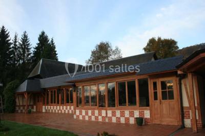 Chambre lumineuse avec lit double, bureau, télévision murale, fauteuil et fenêtre donnant sur l'extérieur.