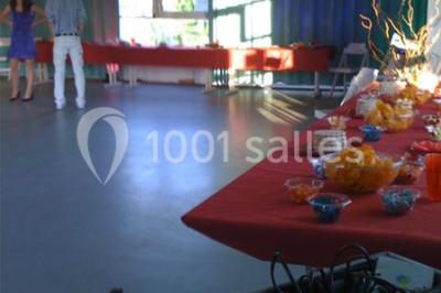 Vue nocturne depuis une fenêtre, montrant un parc éclairé, des arbres et des bâtiments en arrière-plan.