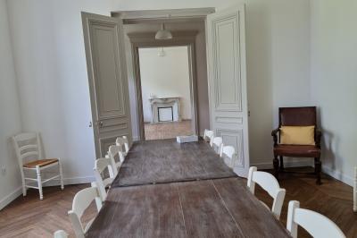 Présentoirs de lunettes de soleil exposés dans une salle lumineuse avec vue sur un espace extérieur verdoyant.