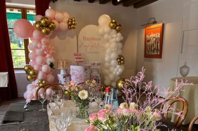 Cour intérieure aménagée avec des poufs colorés, des tables en bois et des guirlandes lumineuses suspendues.