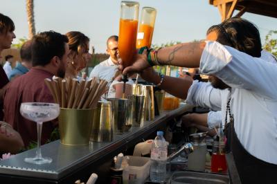 Structure de jeux colorée avec toboggans multiples, située sur un sol en gravier sous un ciel dégagé.