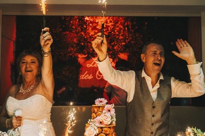 Une personne tranche un filet de saumon sur une planche en bois, avec des toasts préparés en premier plan.