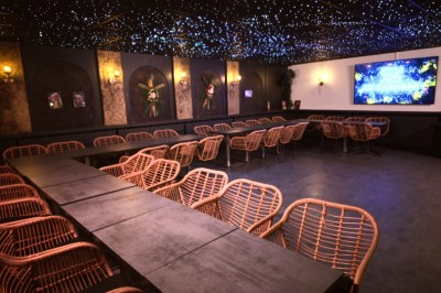 Plateau en bois garni de tacos variés avec garnitures colorées, présenté sur un fond décoratif.