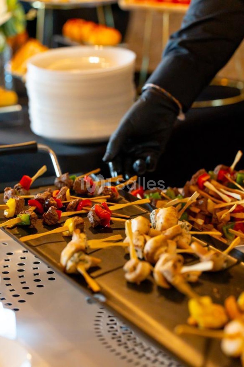 Brochettes variées de légumes et viandes grillées présentées sur un plateau lors d'un buffet.