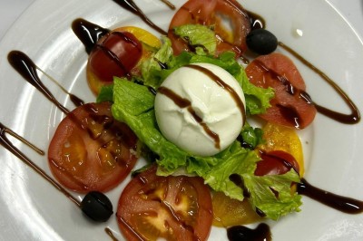Assiettes garnies de viande rôtie, haricots verts, pommes de terre, carottes et décorations de tomates cerises et olives.