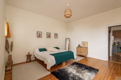 Douche moderne avec paroi en verre, entourée de carreaux dorés brillants formant un motif mosaïque.