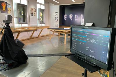 Installation technique avec écrans, projecteurs et équipements audiovisuels dans une salle aux murs clairs.