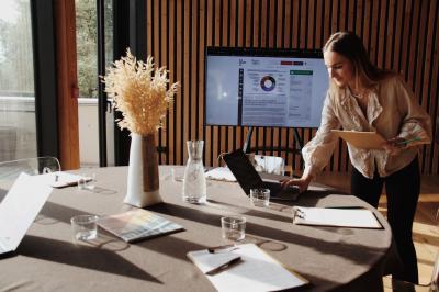 Quatre personnes regardent un coucher de soleil aux teintes orange et violet depuis une terrasse surplombant des vignes.