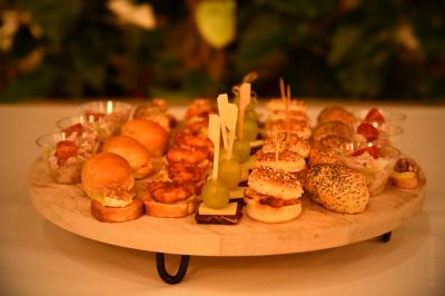Plateau de bouchées apéritives variées comprenant samoussas, brochettes de légumes et crevettes sur toasts.