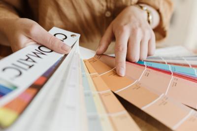 Bougeoirs en laiton et en métal argenté alignés sur des étagères en bois dans un espace de rangement.