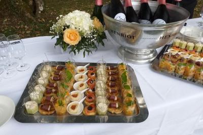 Chambre d'hôtel avec lit double, bureau en bois, lampe suspendue, fenêtre et décoration murale rouge et beige.