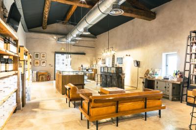 Vue aérienne d'un domaine rural avec bâtiments en pierre, cour pavée, arbres et champs environnants.