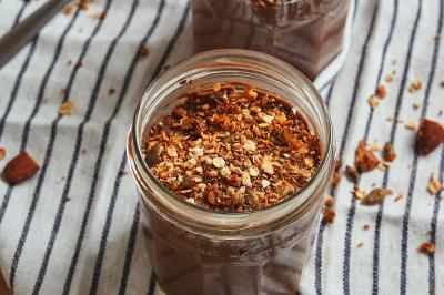 Saumon grillé garni de pousses, accompagné de kimchi, servi dans une assiette en céramique sur une nappe rayée.