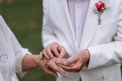 Cuisine professionnelle avec plans de travail en inox, réfrigérateurs, sol en bois clair et murs carrelés gris.
