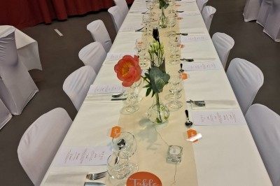 Miniature Traiteur Saint-Martin-le-Vinoux (Isère) - Brusyl - Open K Fe #22 Salle décorée avec des rideaux bleus, guirlandes lumineuses, vases avec branches et une table recouverte d'une nappe blanche.