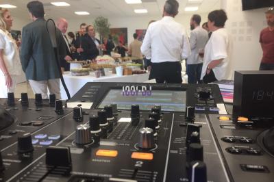 Console DJ Pioneer installée dans une salle de réception avec tables dressées en arrière-plan.