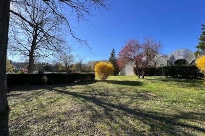 Laverie avec machines à laver, sèche-linge, éviers, miroirs et cabines jaunes dans un espace carrelé.