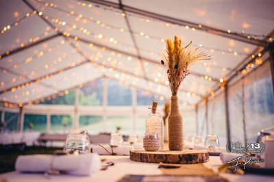Plaque en pierre gravée avec des inscriptions dorées et un motif de croix ailée au-dessus du texte.