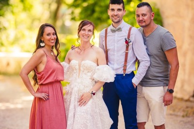 Plaque en pierre gravée avec des inscriptions dorées et un motif de croix ailée au-dessus du texte.