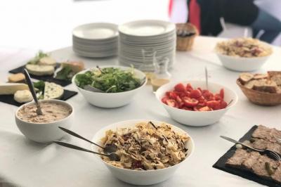 Buffet avec des amuse-bouches variés présentés sur des plateaux en bois et des verrines en arrière-plan.