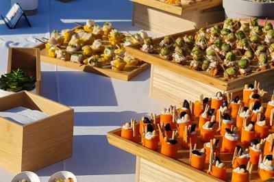 Salle de réception décorée avec des tables rondes dressées, nappes blanches, verres et couverts élégants.