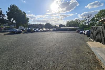 Salle de réception élégante décorée de nappes blanches, chaises habillées et centres de table floraux.