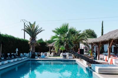 Salle de réception élégante avec tables rondes décorées de fleurs blanches et serviettes pliées, ambiance lumineuse.