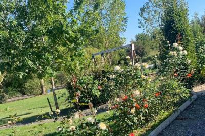 Tables rondes empilées verticalement et chaises empilées dans un couloir étroit avec un sol en carrelage gris.