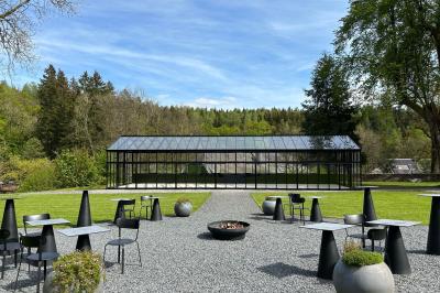 Deux colonnes en pierre encadrent un espace avec deux bureaux modernes, éclairés par des lampes murales.