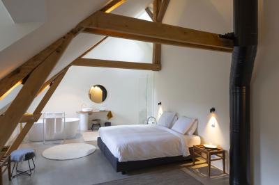 Deux colonnes en pierre encadrent un espace avec deux bureaux modernes, éclairés par des lampes murales.