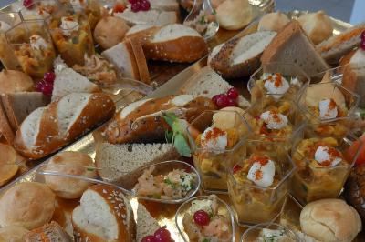 Un couple coupe un gâteau éclairé de bougies étincelantes lors d'une fête dans une salle décorée.