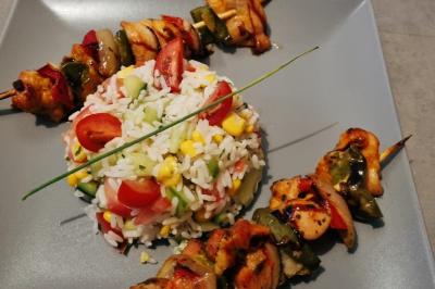 Huîtres gratinées garnies de fromage et épices, présentées sur un plateau en bois, avec légumes en arrière-plan.