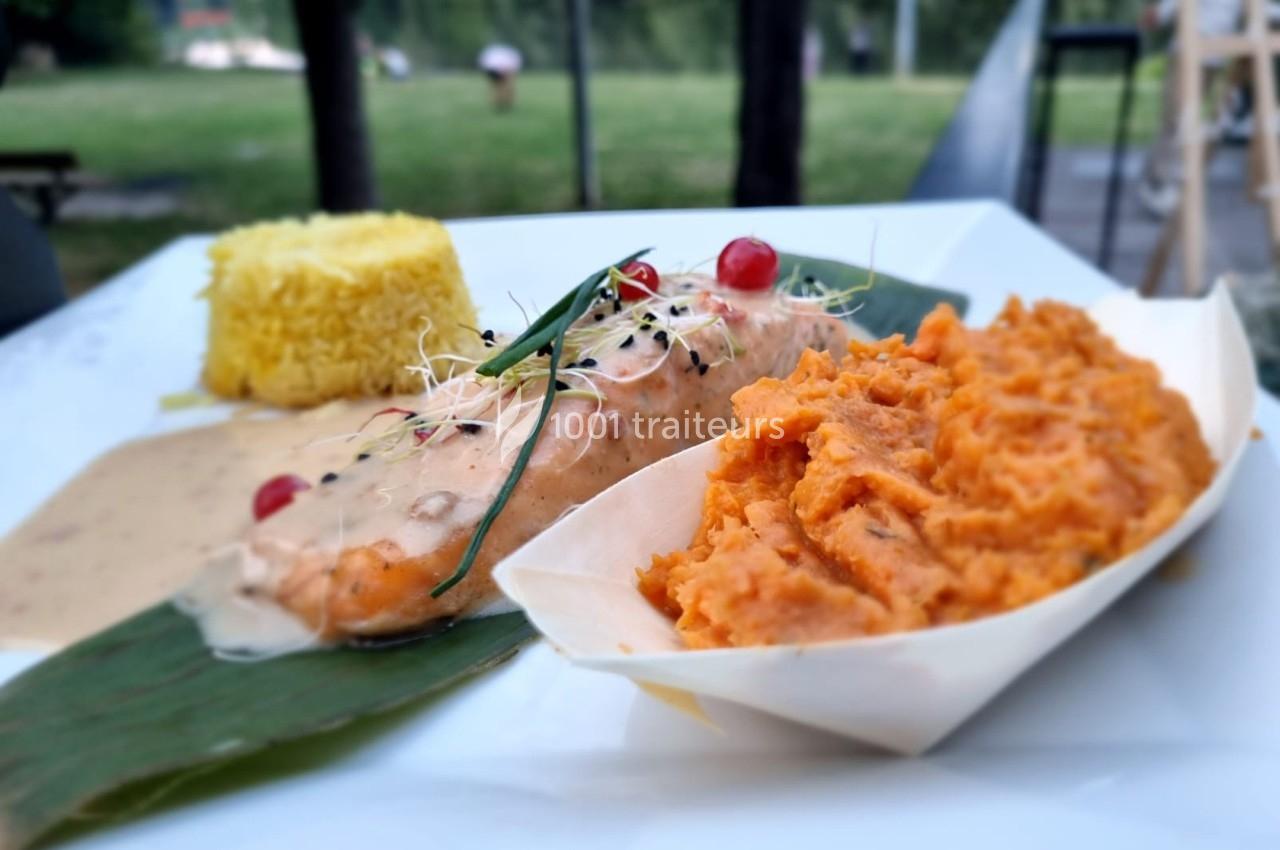Assiette avec filet de poisson en sauce, purée de patates douces, riz safrané et garniture de graines et herbes.