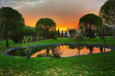 Décoration de table de mariage en extérieur avec chandeliers en verre, fleurs blanches et chaises alignées sur une pelouse.
