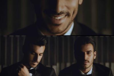 Un couple en tenue de mariage traditionnelle, l'homme en sherwani blanc et la femme en robe brodée rouge.