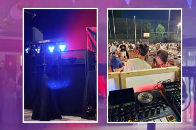 Main ajustant des réglages sur une table de mixage DJ lumineuse avec des écrans et des boutons colorés.