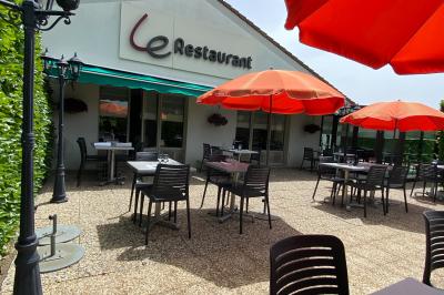 Salle de bain moderne avec lavabo, miroir, toilettes et douche vitrée sur un sol en carrelage gris.