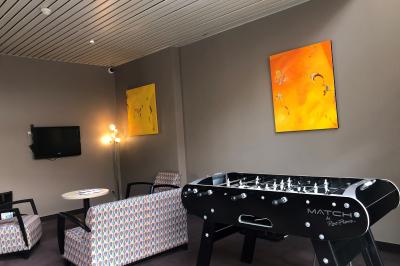 Salle de réunion avec tables disposées en U, bouteilles d'eau, stylos et blocs-notes sur chaque place.