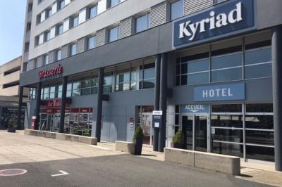 Salle de réunion avec tables disposées en U, bouteilles d'eau, stylos et blocs-notes sur chaque place.