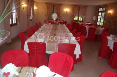 Miniature Location salle Saint-Aubin-sur-Gaillon (Eure) - Château de Beauchêne #9 Cheminée en pierre avec poutres en bois apparentes, ornée d'une composition florale dans une pièce lumineuse.